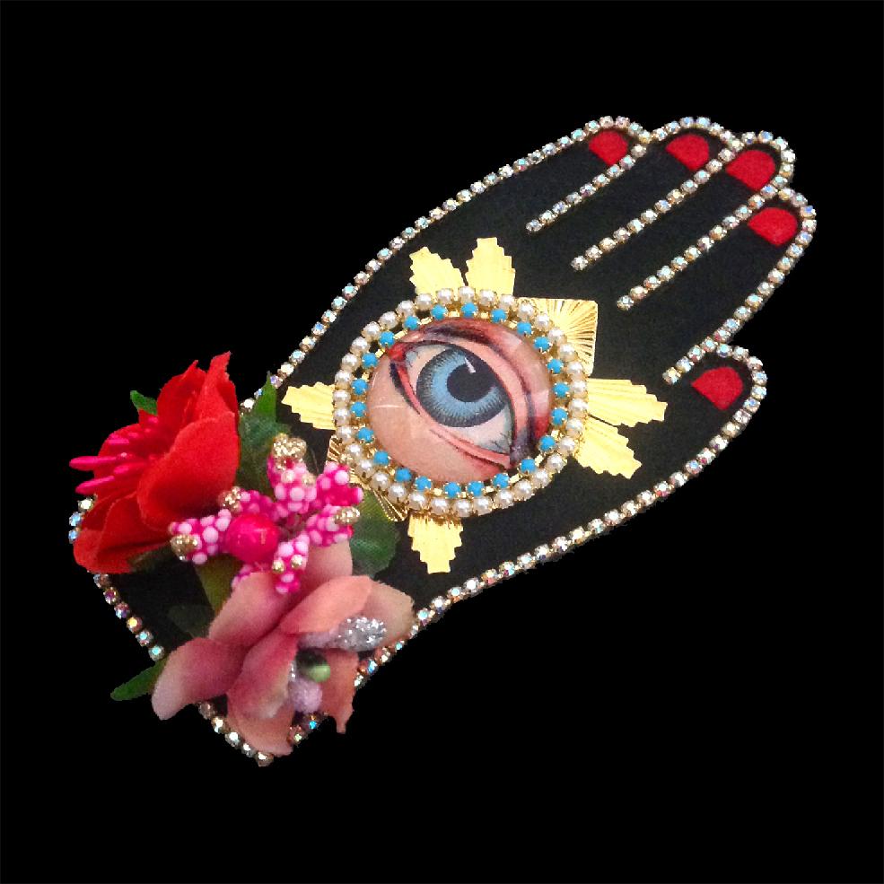 mouchkine jewelry couture and sophisticated hand brooch with antique eye, surrounded by flowers