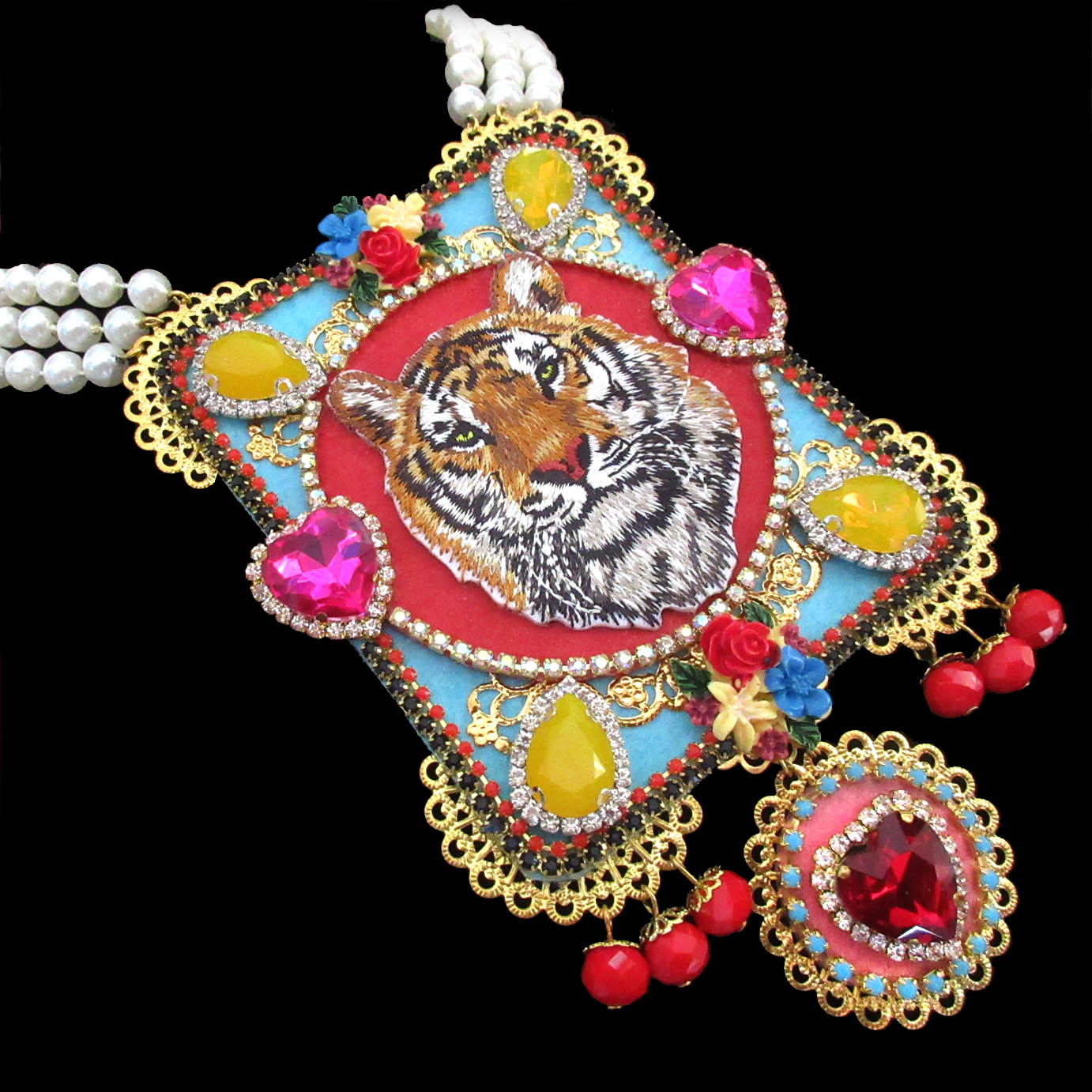 mouchkine jewelry luxury tiger necklace, ornate with an embroided tiger, pink glass hearts, yellow chipped citrine stones, and delicate red glass pearls.
