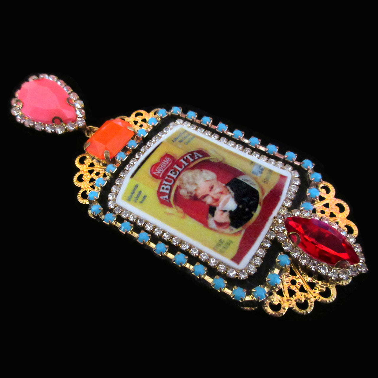 mouchkine jewelry earrings, an abuelita chic picture with red, pink and orange crystals. A luxury haute couture creation.