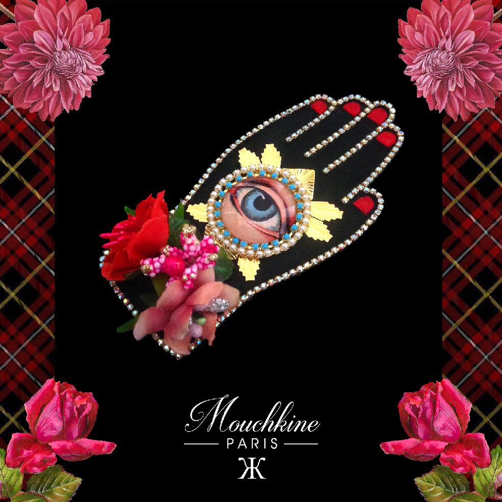 mouchkine jewelry couture and sophisticated hand brooch with antique eye, surrounded by flowers